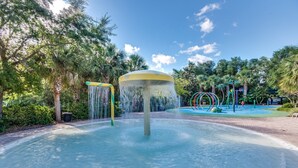 A water feature with a central fountain and surrounding greenery. - Bahama Bay - Minutes from Disney Theme Parks! (Davenport)