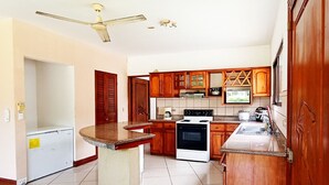 A kitchen with wooden cabinets, a built-in oven, and a countertop island.