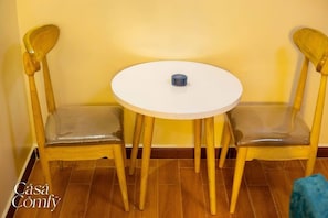 Sit and enjoy meals in this charming dining area with a round table and comfortable chairs.