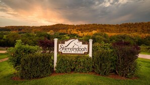 A sign for Shenandoah Riding Center surrounded by greenery and a forested hill in the background. - Partridge Place | 4 Ensuite Bedrooms, Hot Tub, Fire Pit, Dog-Friendly (Galena)
