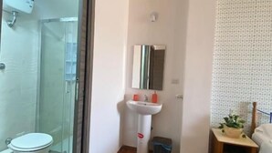 A bathroom with a toilet, sink, and shower. - Milazzo Luxury Home (Rome)