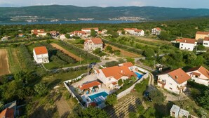 An aerial view of a residential area with houses, a swimming pool, and a road. - Stunning home in Pridraga (Pridraga)