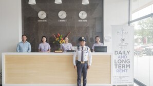 A reception desk with clocks indicating time in Cagayan de Oro, Rome, and New York. A signboard advertises daily and long-term rent. - Prima at Primavera City (Cagayan de Oro)