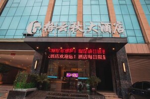 A hotel entrance with a modern glass facade and a sign indicating a hotel with a name that suggests a focus on leisure or entertainment.