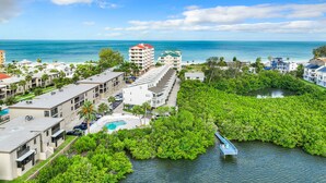 A coastal hotel with multiple buildings, a swimming pool, and mangrove-lined waterways. - ★Gulf Coast 107★ Heated Pool + Beach Gear, Steps to Beach! Clean&Spacious Condo (Indian Shores)