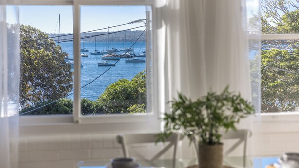 A room with a view of boats on the water through a window. - Luxe-Coastal Balmoral Beachfront (Mosman)