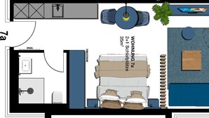 A hotel room layout with a bed, bedside table, wardrobe, bathroom, and a small seating area with a table and chairs. - 1-room vacation apartment with balcony (Seebad Heringsdorf)