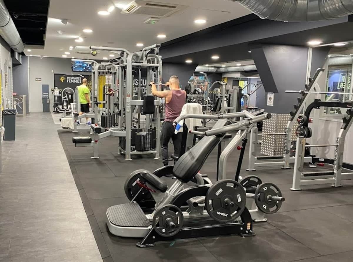 A gym with various exercise equipment, including a bench press and weight machines.