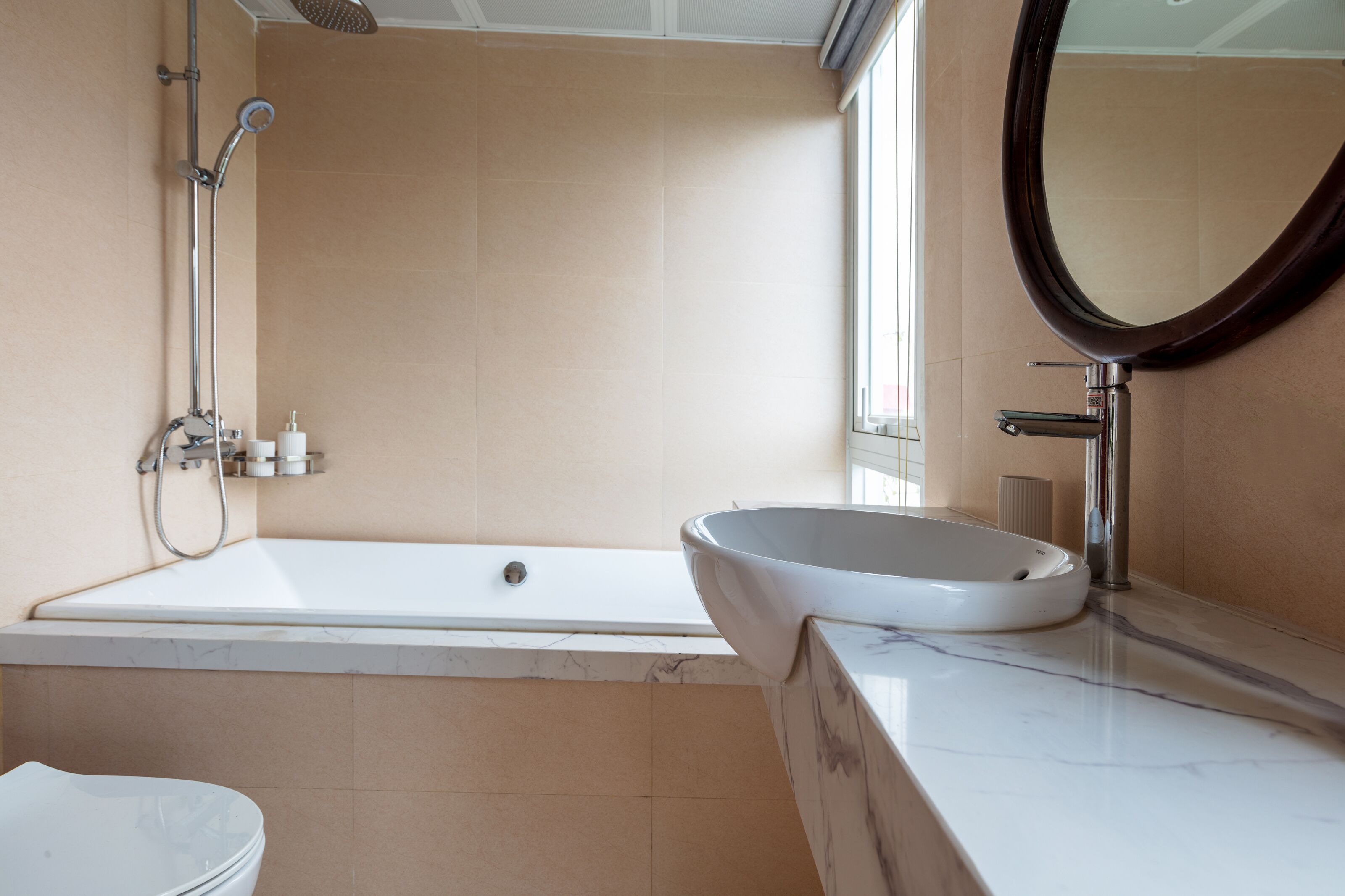 A modern bathroom with a bathtub, a sink, and a toilet.