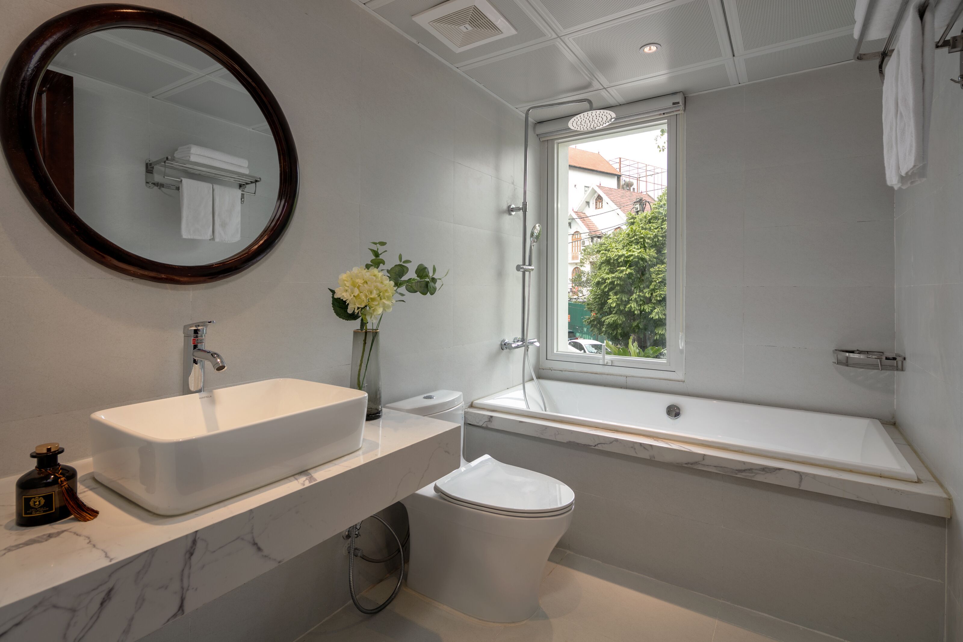 A modern bathroom with a white sink, toilet, and bathtub.