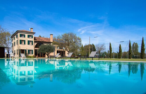 Villa with swimming pool surrounded by greenery