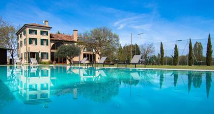 Villa with swimming pool surrounded by greenery