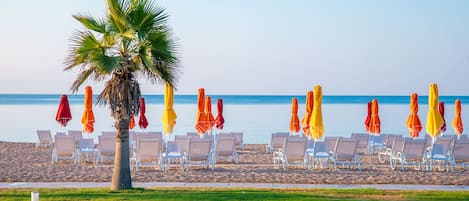 On the beach, sun loungers, beach umbrellas, beach bar