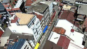 An aerial view of a multi-story building with a mix of residential and commercial spaces, including a visible storefront on the ground floor. - Linda Port Hotel (Istanbul)