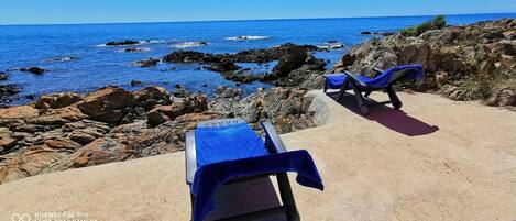 On the beach, sun-loungers