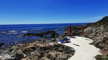 On the beach, sun-loungers