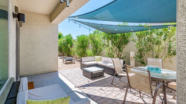 A patio area with a sofa, chairs, a table, and a canopy. - Modern, 3 Bedroom Home Near Superstition Mountain! (Apache Junction)