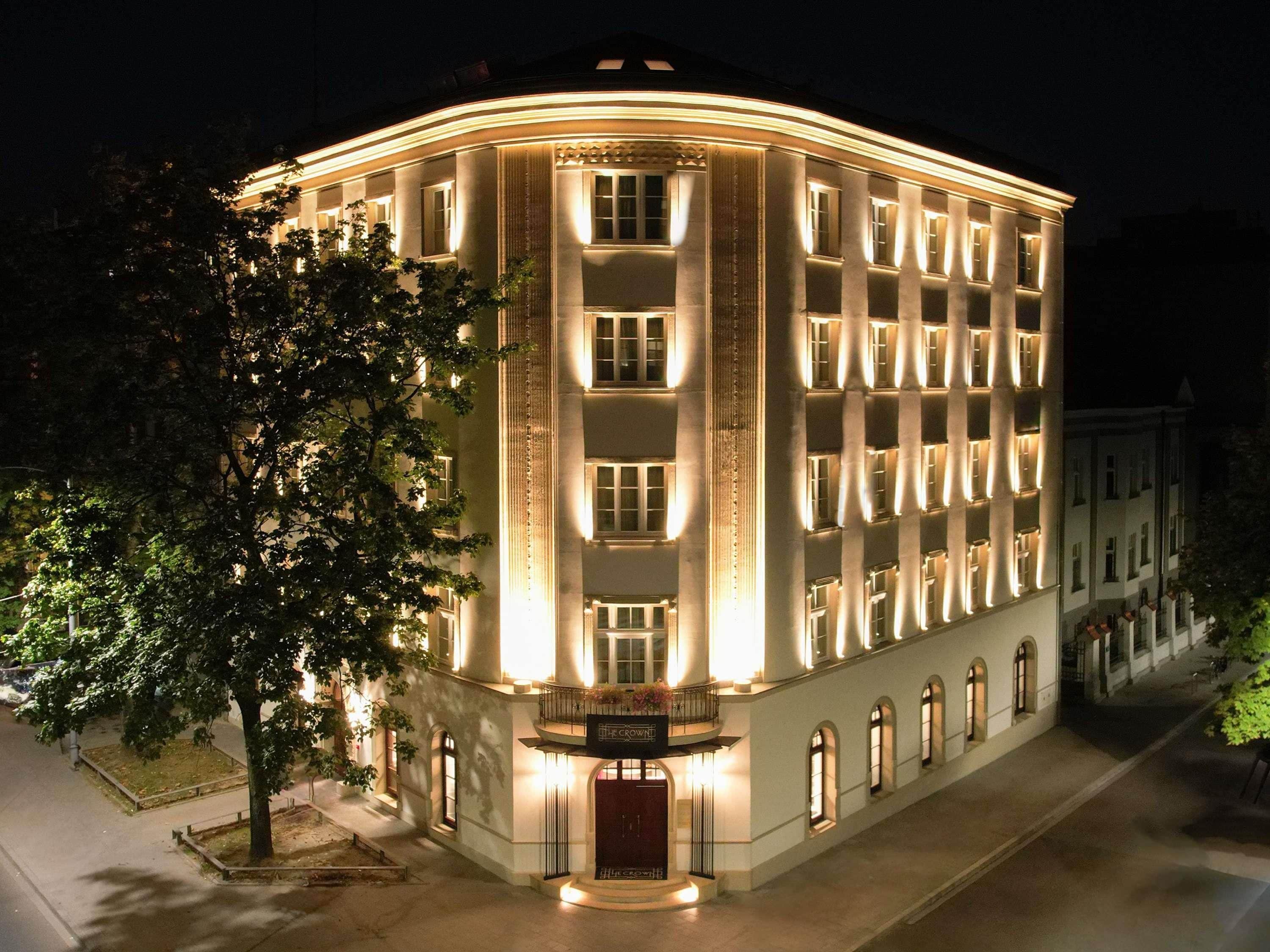 A multi-story building with a curved facade, large windows, and a central entrance.