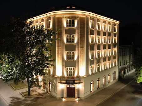 A multi-story building with a curved facade, large windows, and a central entrance.. The Crown Krakow Center - Handwritten Collection ACCOR