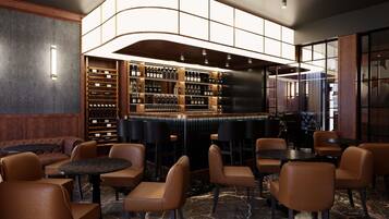 A bar area with seating, marble flooring, and a wine display.
