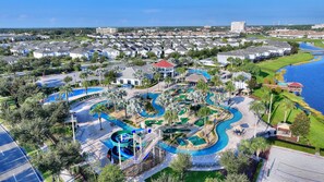 A resort with a large pool area, a water slide, and a view of the surrounding residential area. - 4577 Sleeps 18! Lego Game Room & Private Pool (Kissimmee)