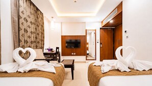 A hotel room with two beds, a TV, a desk, and a mirror. - La Grrande Malar - The Boutique Hotel Pondicherry (Puducherry)