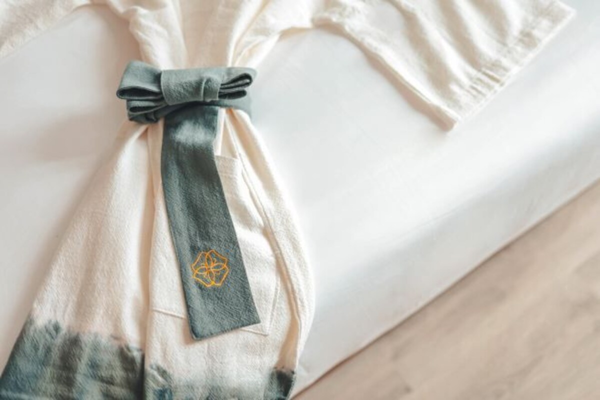 A tie with a geometric pattern tied to a white shirt.