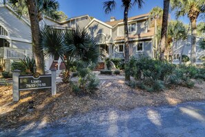 Units 7615-7618 offer an entrance with a well-manicured yard and paved driveway.