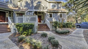 A two-story house with a front porch, a staircase, and a driveway. - SALT LIFE TREEHOUSE --BEAUTIFUL VIEWS! Huntington Villas (Hilton Head Island)