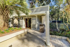 Enjoy a serene outdoor space with a pool nearby, surrounded by lush greenery and modern architecture.