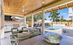 An outdoor patio with a pool, seating area, and a barbecue setup. - Luxury Private Pool - Golf Cart - Pet Friendly! (Santa Rosa Beach)