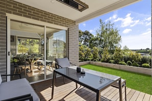 Relax on the patio surrounded by lush greenery and enjoy the view of the neighborhood.