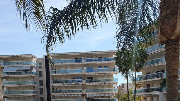 A residential building with multiple balconies, a swimming pool, and well-maintained lawns. - Beach apartment (Salou)