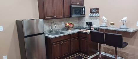 Fridge, microwave, stovetop, coffee/tea maker