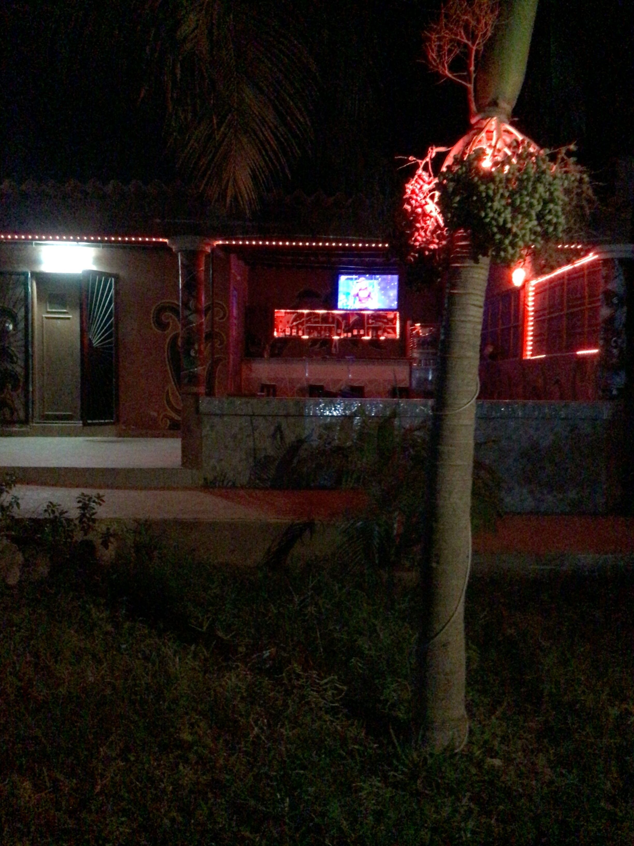 A house with a bar area featuring a television.