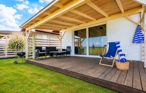 An outdoor deck with a pergola, a barbecue grill, and outdoor seating. - 2 bedroom stunning home in Jaroslawiec (Jaroslawiec)