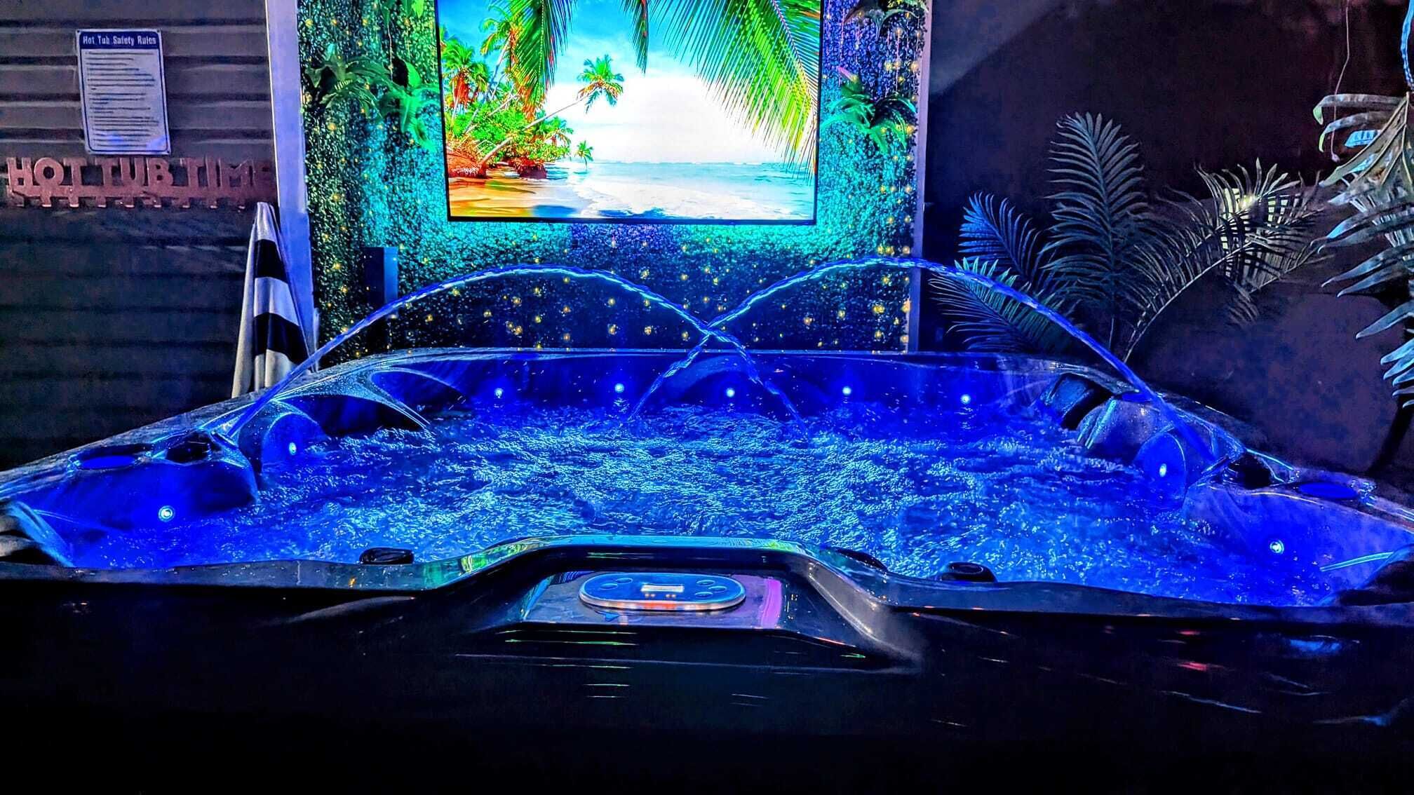 A hot tub with a digital screen displaying a tropical beach scene.