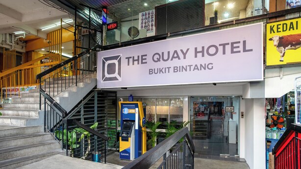 A hotel entrance with a staircase leading up to it, an ATM machine, and a sign for 'The Quay Hotel Bukit Bintang'. - The Quay Hotel Bukit Bintang (Kuala Lumpur)