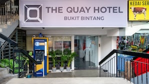 The Quay Hotel entrance with a sign, an ATM, and potted plants. - The Quay Hotel Bukit Bintang (Kuala Lumpur)