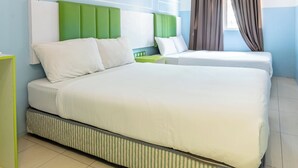 A modern hotel room with a large bed, two bedside tables, a green accent wall, and a window with curtains. - The Quay Hotel Bukit Bintang (Kuala Lumpur)