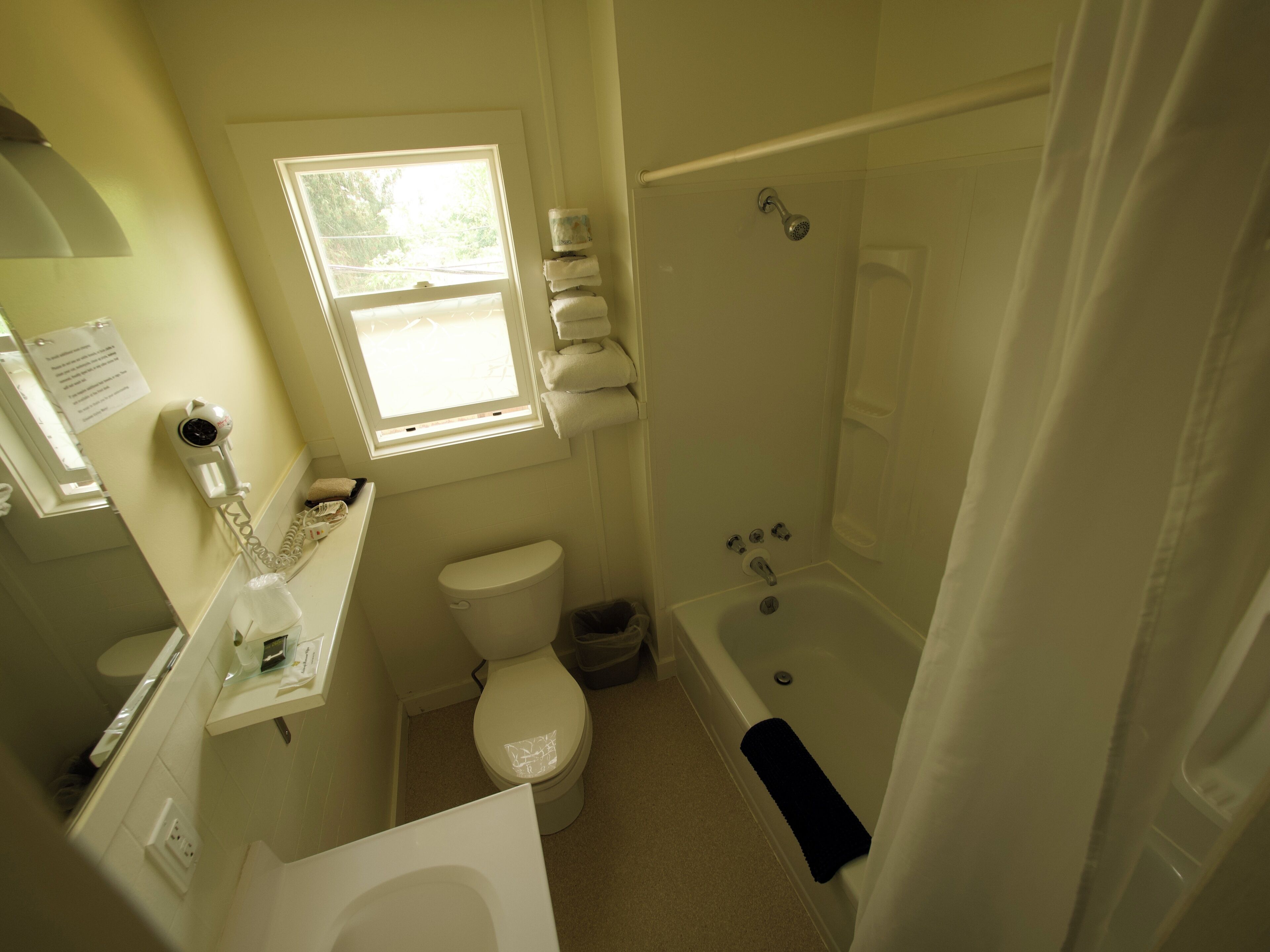 A bathroom with a toilet, sink, and bathtub.