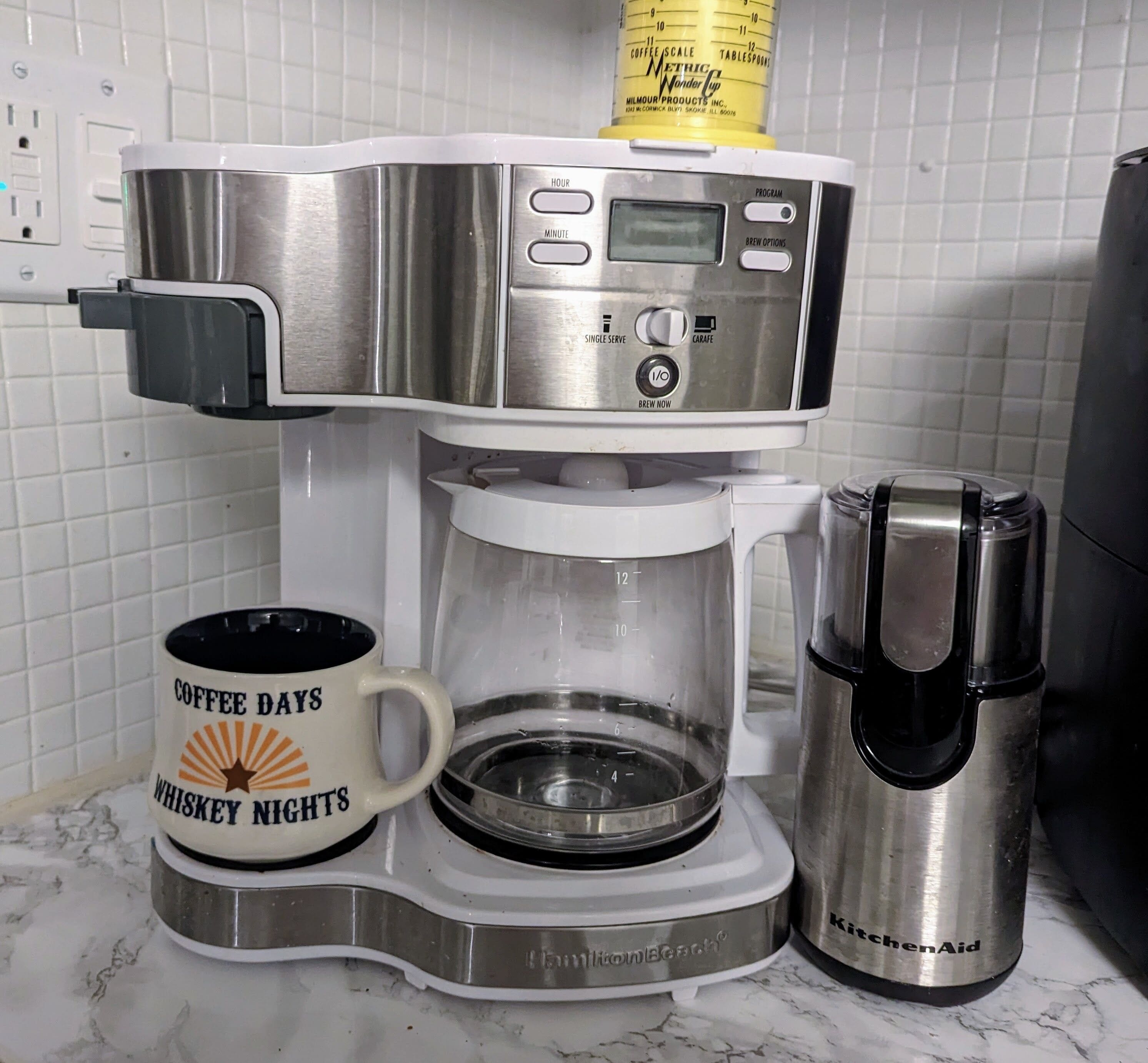 A coffee maker with a digital display and a coffee scale on top.