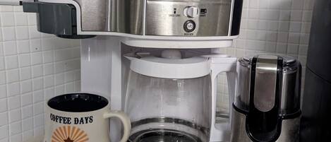 A coffee maker with a digital display and a coffee scale on top.