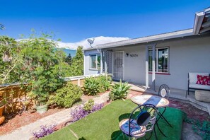 A residential property with a patio area, a small garden, and a white exterior wall. - Chic, Playful Boho Bungalow Near Everything! (La Mesa)