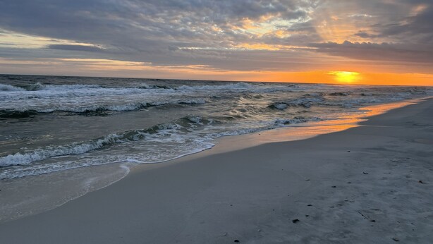 A beach with waves and a sunset. - Convenient to everything! Only steps to the beach. (Gulf Shores)