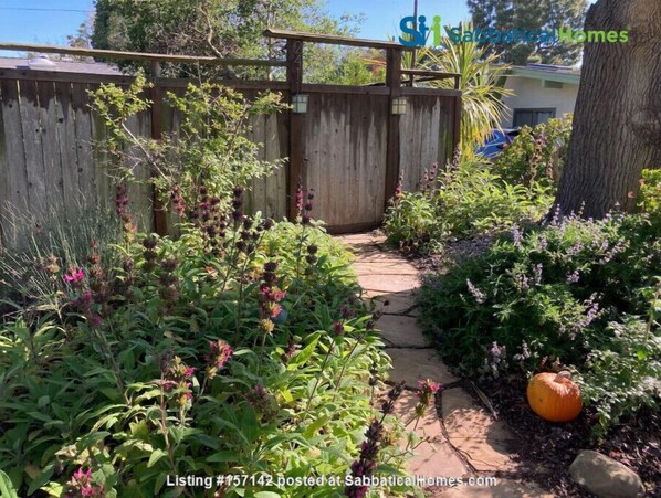 Stroll through the beautifully maintained garden, surrounded by vibrant flowers and lush greenery.