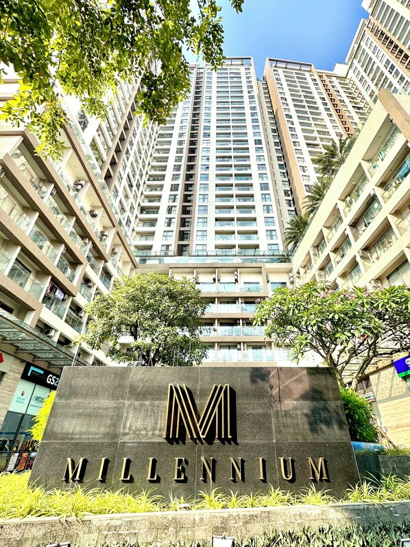 A high-rise building with a sign reading "MILLENNIUM" in front. - MILLENIUM - Luxury Central Apartments (Ho Chi Minh City)