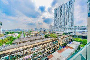 A high-rise building with multiple floors, surrounded by other buildings and greenery. - MILLENIUM - Luxury Central Apartments (Ho Chi Minh City)