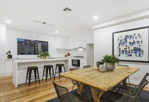Enjoy meals in the well-appointed kitchen and dining area with a central island and pendant lighting.