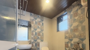 A bathroom with a toilet, sink, shower, and a window. - Canal Touch Resort (Karjat)